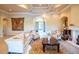 Inviting living room with an elegant fireplace, coffered ceiling, and comfortable seating at 15101 Kestrelglen Way, Lithia, FL 33547
