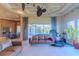 Spacious living room with comfortable seating, large windows, and views of the outdoor space at 15101 Kestrelglen Way, Lithia, FL 33547