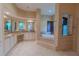 Main bathroom with double vanity, soaking tub, tiled shower, and a bright, open design at 15101 Kestrelglen Way, Lithia, FL 33547