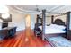 Main bedroom features a dark wood canopy bed, hardwood floors, and an adjacent desk area at 15101 Kestrelglen Way, Lithia, FL 33547
