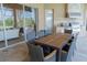 Covered outdoor dining area with large table, chairs, and stainless steel kitchen features at 15101 Kestrelglen Way, Lithia, FL 33547