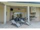 Outdoor kitchen and dining area featuring grill, refrigerator, and seating for elegant entertaining at 15101 Kestrelglen Way, Lithia, FL 33547