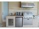 Outdoor kitchen featuring stainless steel appliances and tile backsplash at 15101 Kestrelglen Way, Lithia, FL 33547
