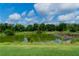 Scenic view of a pond surrounded by lush greenery and a vibrant blue sky with fluffy white clouds at 15101 Kestrelglen Way, Lithia, FL 33547