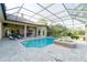 A screened in pool and spa provide a luxurious backyard retreat with serene views at 15101 Kestrelglen Way, Lithia, FL 33547