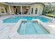 A large heated pool with integrated hot tub invites leisure and relaxation on a sunny day at 15101 Kestrelglen Way, Lithia, FL 33547