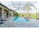 Relax by the sparkling pool, encased within a screened lanai with lush outdoor views at 15101 Kestrelglen Way, Lithia, FL 33547