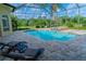 This screened-in pool and patio offer the perfect space for outdoor relaxation and entertainment at 15101 Kestrelglen Way, Lithia, FL 33547