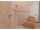 Walk-in shower features a built-in bench, beautiful tile, and a sleek shower head at 15101 Kestrelglen Way, Lithia, FL 33547