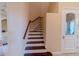 Beautiful staircase features a dark wood banister and white risers at 15101 Kestrelglen Way, Lithia, FL 33547