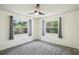 Inviting bedroom filled with natural light from the windows and soft carpet flooring at 166 11Th N Ave, Safety Harbor, FL 34695