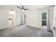 Cozy bedroom featuring plush carpeting, natural light from windows, and a ceiling fan at 166 11Th N Ave, Safety Harbor, FL 34695