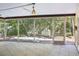 Screened porch with tile flooring, perfect for enjoying the outdoors in comfort at 166 11Th N Ave, Safety Harbor, FL 34695