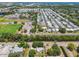 Aerial view showcases a community with neatly arranged homes, a sports field, and parking at 1810 77Th N Ave, St Petersburg, FL 33702
