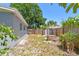 Backyard with wooden fence, mature trees, and storage shed; great for outdoor activities at 1810 77Th N Ave, St Petersburg, FL 33702