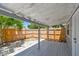 Relaxing covered deck area in a private backyard with wooden fence at 1810 77Th N Ave, St Petersburg, FL 33702
