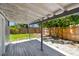 Covered backyard deck overlooking a fenced yard and mature trees at 1810 77Th N Ave, St Petersburg, FL 33702