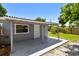 Covered backyard patio and lush greenery with privacy fence at 1810 77Th N Ave, St Petersburg, FL 33702
