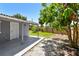 Backyard view featuring a covered porch, gravel, grass, and mature mango tree at 1810 77Th N Ave, St Petersburg, FL 33702