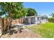 Fenced backyard view featuring the home's exterior, a deck, and a grass area at 1810 77Th N Ave, St Petersburg, FL 33702