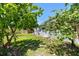 The backyard showcases a mix of grass, mature landscaping, and a wooden fence at 1810 77Th N Ave, St Petersburg, FL 33702