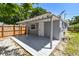 Inviting covered patio area and lush greenery with surrounding fence at 1810 77Th N Ave, St Petersburg, FL 33702