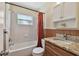 Well-lit bathroom showcasing tile, bathtub, updated vanity, and shower with curtain at 1810 77Th N Ave, St Petersburg, FL 33702