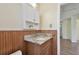Bathroom featuring wood wainscotting, granite vanity, and a decorative wall cabinet at 1810 77Th N Ave, St Petersburg, FL 33702