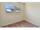 Neutral bedroom showcasing wood-look floors, a window, and baseboard trim at 1810 77Th N Ave, St Petersburg, FL 33702
