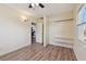 Bedroom features wood-look flooring, open closet, and a view of the entry way at 1810 77Th N Ave, St Petersburg, FL 33702