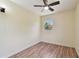 Light filled bedroom featuring wood-look floors, a ceiling fan and a sunlit window at 1810 77Th N Ave, St Petersburg, FL 33702