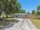 Well-maintained single-Gathering home with a long driveway and manicured front yard at 1810 77Th N Ave, St Petersburg, FL 33702