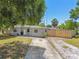 Well-maintained single-Gathering home with a spacious driveway and beautifully landscaped front yard at 1810 77Th N Ave, St Petersburg, FL 33702