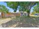 Quaint single-Gathering home with privacy fence, featuring neat landscaping and mature shade trees at 1810 77Th N Ave, St Petersburg, FL 33702