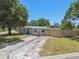 Charming single-Gathering home with a long driveway and a well-maintained lawn at 1810 77Th N Ave, St Petersburg, FL 33702