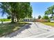 Beautiful home with mature shade trees in the front yard, set back from the street with a long driveway and landscaping at 1810 77Th N Ave, St Petersburg, FL 33702