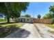 This beautiful home has well-maintained landscaping with mature trees and a long driveway, enhancing its curb appeal at 1810 77Th N Ave, St Petersburg, FL 33702