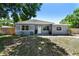 Well-maintained one-story home boasting a tidy front yard, gray paint, white trim, and a welcoming entrance at 1810 77Th N Ave, St Petersburg, FL 33702