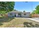 A well-maintained home features a manicured lawn and inviting entry, enhancing its curb appeal in a quiet neighborhood at 1810 77Th N Ave, St Petersburg, FL 33702