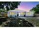 Charming single-story home featuring gray paint, white trim, a well-maintained yard, and a welcoming front entrance at 1810 77Th N Ave, St Petersburg, FL 33702