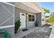 Welcoming front porch featuring a white door and decorative plants, creating an inviting entrance at 1810 77Th N Ave, St Petersburg, FL 33702