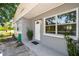 Welcoming front entrance with a white door, large window and a potted plant at 1810 77Th N Ave, St Petersburg, FL 33702