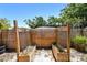 Raised garden beds fenced in on sandy soil with sparse growth in the backyard at 1810 77Th N Ave, St Petersburg, FL 33702