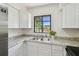 Kitchen with granite countertop, stainless steel sink, and bright window overlooking the outdoors at 1810 77Th N Ave, St Petersburg, FL 33702