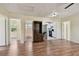 Open living room showcasing vinyl flooring, a view of the bathroom, and seamless flow into the kitchen at 1810 77Th N Ave, St Petersburg, FL 33702