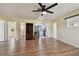 Bright living room with modern ceiling fan, stylish vinyl plank flooring, and easy access to the kitchen and bedrooms at 1810 77Th N Ave, St Petersburg, FL 33702