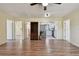 Open-concept living room featuring newer vinyl plank flooring, plenty of natural light, and views into the kitchen at 1810 77Th N Ave, St Petersburg, FL 33702
