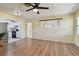 Well-lit living room with vinyl plank flooring, open floor plan, and easy access to the kitchen at 1810 77Th N Ave, St Petersburg, FL 33702