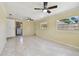 Expansive living room featuring tile floors, ceiling fans, and natural light from multiple windows at 1810 77Th N Ave, St Petersburg, FL 33702
