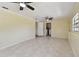 Bright living room with neutral walls, tile floors, and access to laundry area at 1810 77Th N Ave, St Petersburg, FL 33702
